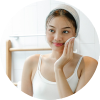 girl cleans face with cotton wool