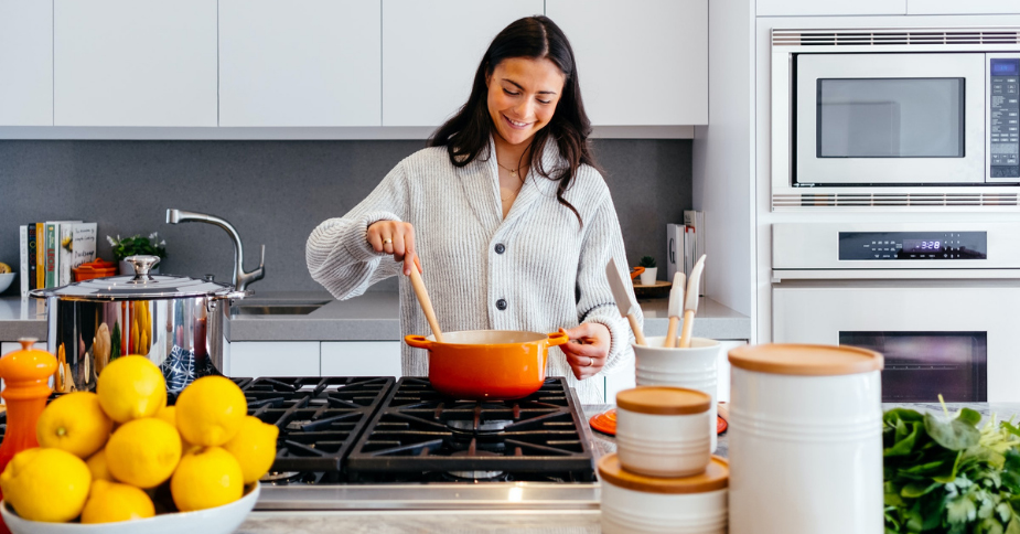 Woman stirring pot on the stove