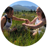 girls in a green meadow with flowers